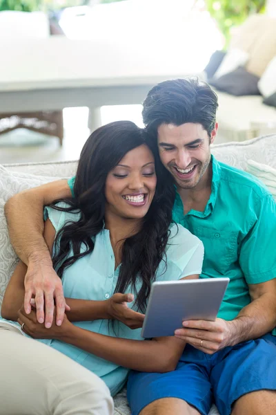 Couple on sofa using tablet