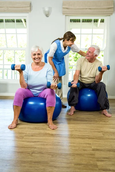 Man and woman holding dumbbellls