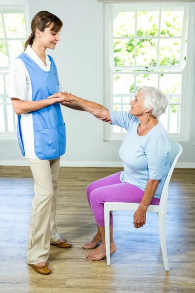 Woman stretching hand with nurse