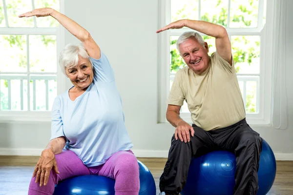 Senior man and woman exercising