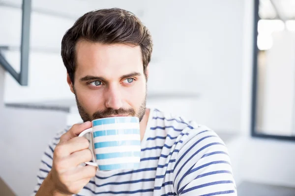 Handsome man having cup of coffee