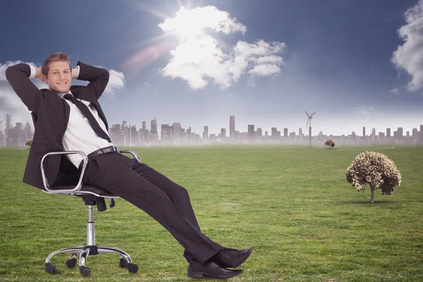 Businessman relaxing in swivel chair