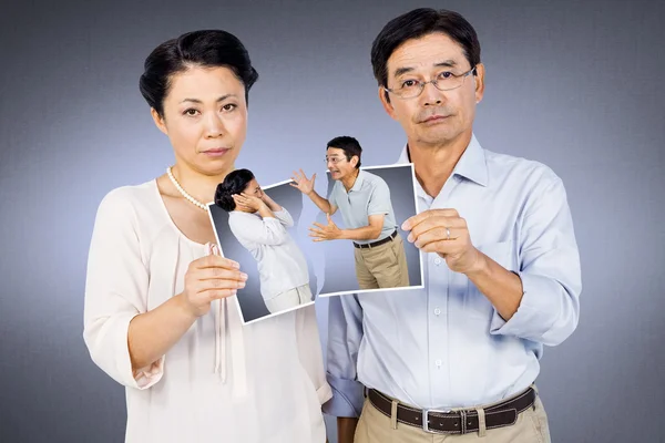 Asian couple holding photo