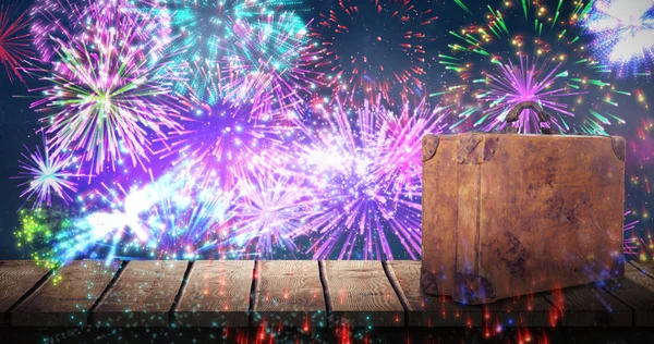 Suitcase against fireworks exploding