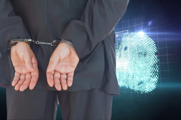 Businessman in handcuffs against finger print