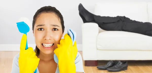 Woman holding cloth and scrubbing brush