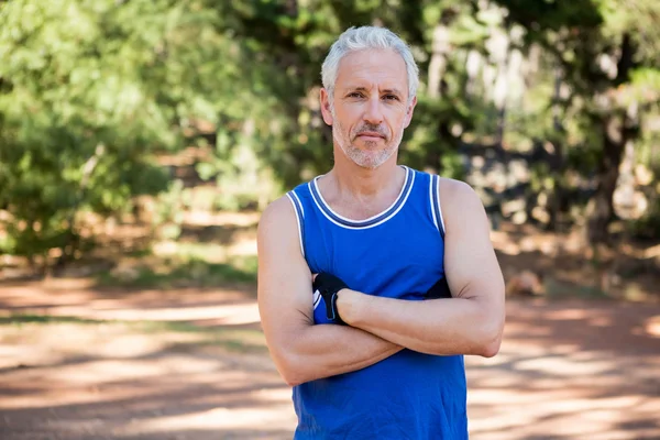 Mature man posing with arms crossed