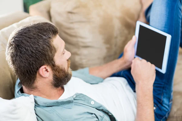 Man using a digital tablet in living room