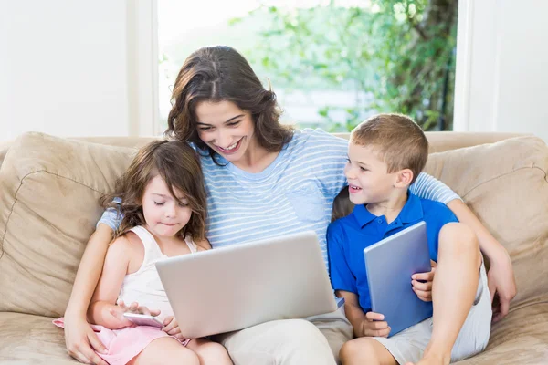 Family using laptop, digital tablet and mobile phone