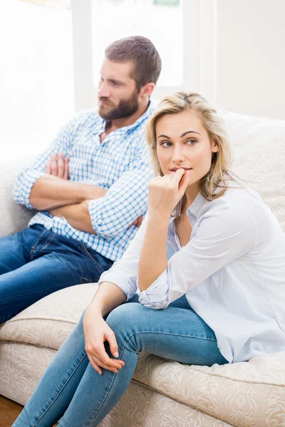 Young couple ignoring each other in living room