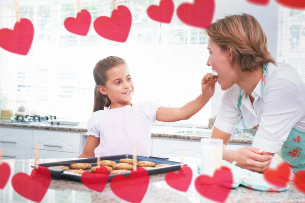 Mother and daughter with hot fresh cookies