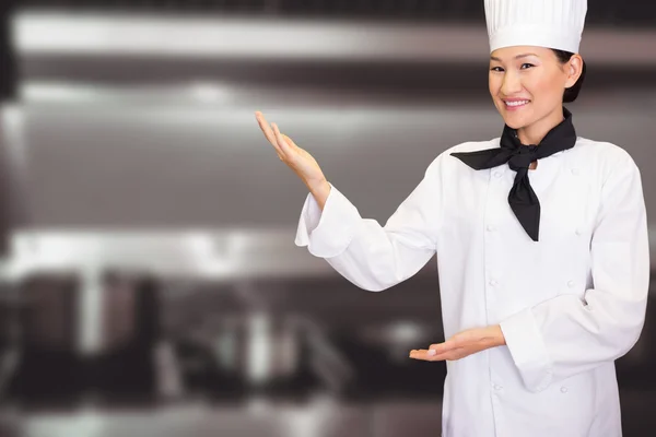 Smiling female cook in kitchen