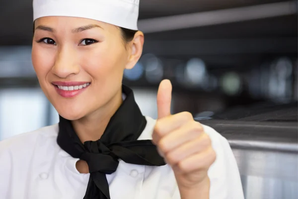 smiling female cook gesturing thumbs up
