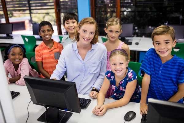 Teacher giving lesson to her students with technology