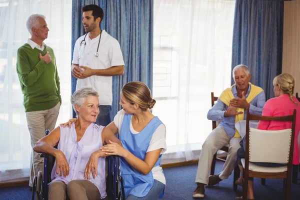 Nurses having discussions with seniors patients