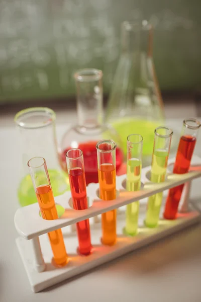 Test tube and beaker on desk