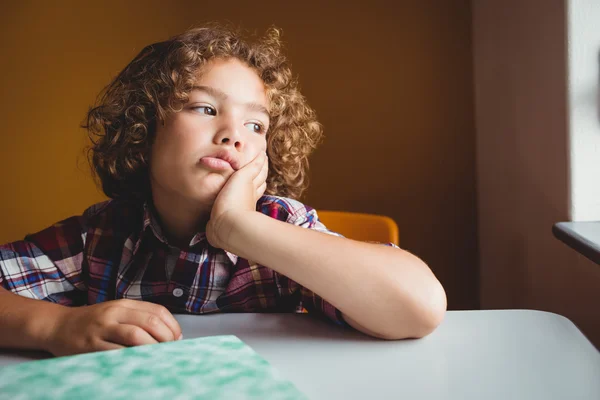 Boy sitting down on his chair and dreaming