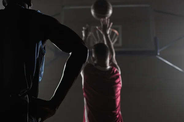 Rear view of a player shooting a basketball