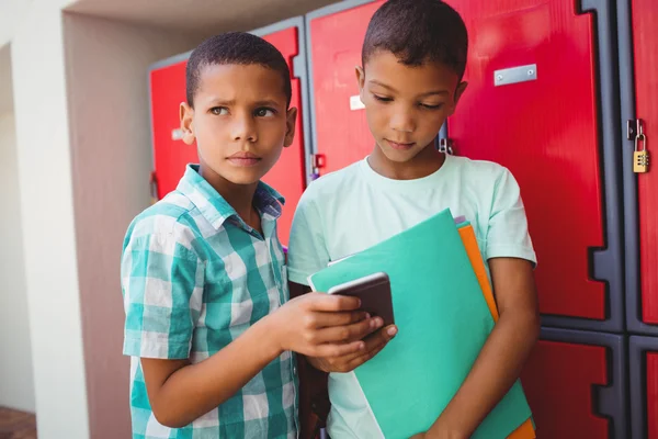 Boys with smartphone in the corridor