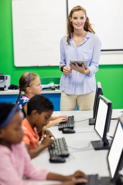 Teacher giving lesson to her students with technology