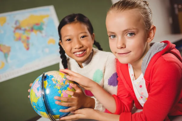 Girls studying the globe