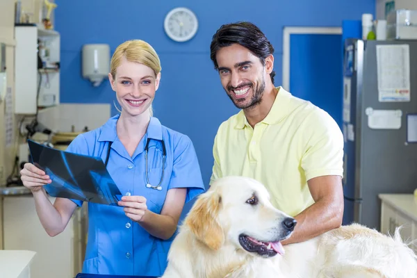 Woman vet and dogs owner smiling and posing