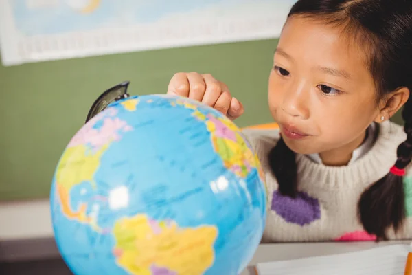 Girl studying the globe