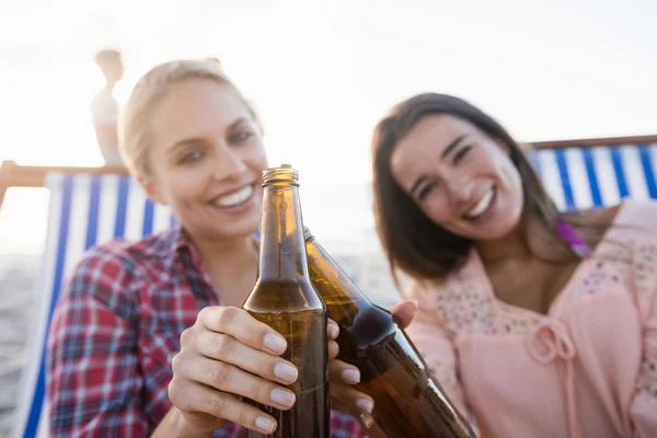 Smiling friends cheering with beer