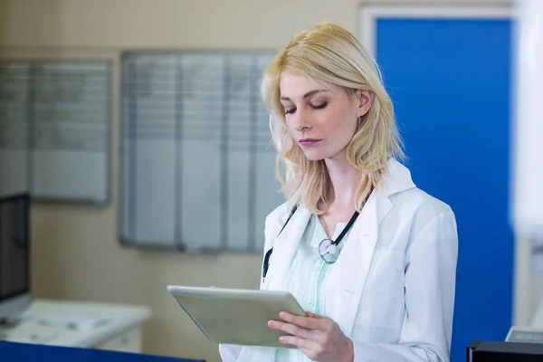 Portrait of concentrated woman vet using a tablet