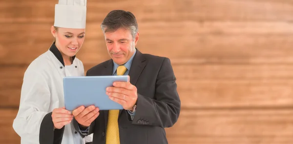 Businessman and female chef using digital tablet