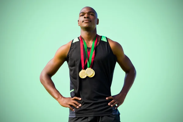 Athletic man posing with medals