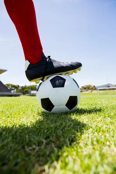 Football player with feet on ball