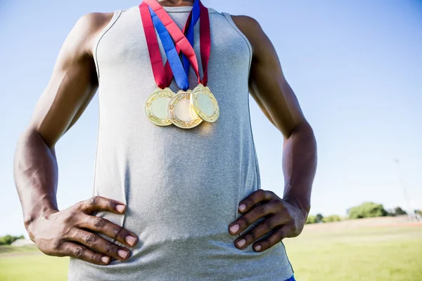 Athlete posing with gold medals