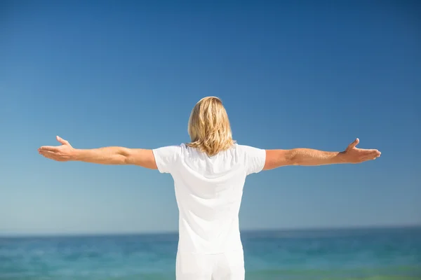 Man standing with arms stretched