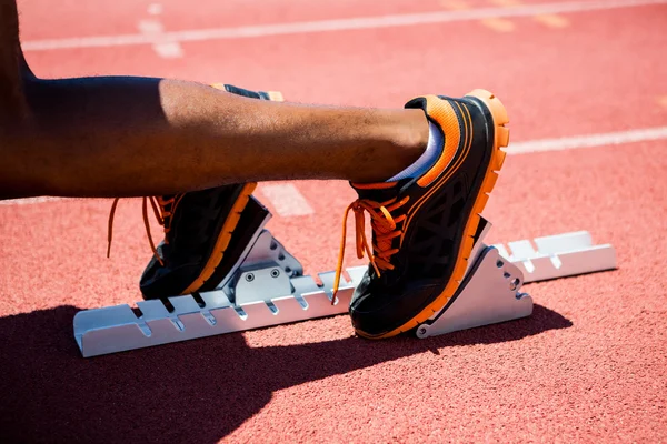 Feet of an athlete on starting block