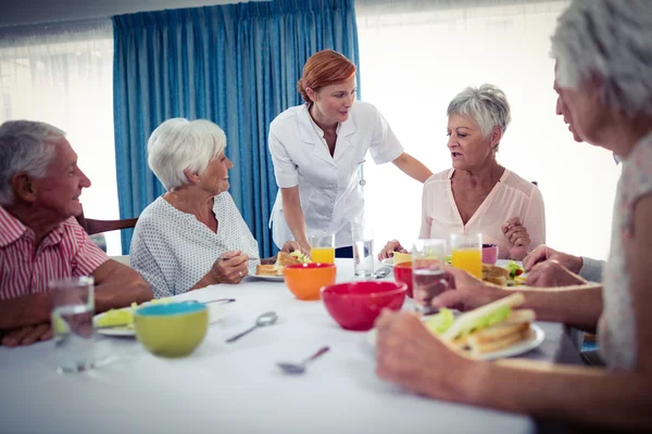 Pensioners at lunch in retirement house