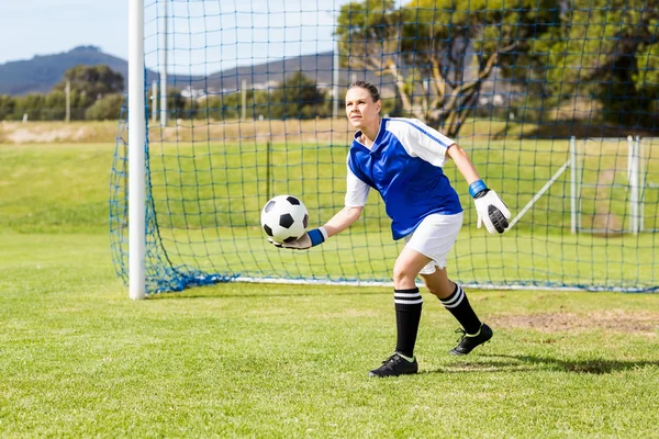 Female goalkeeper about to throw football