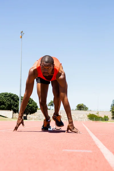 Athlete on starting block about to run