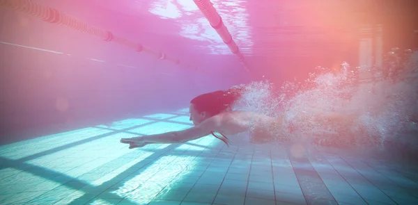 Swimmer swimming underwater in bikini