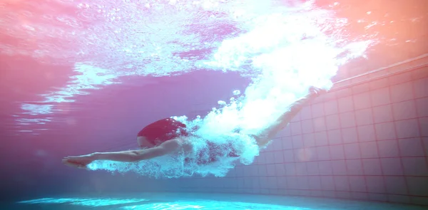 Swimmer smiling at camera underwater