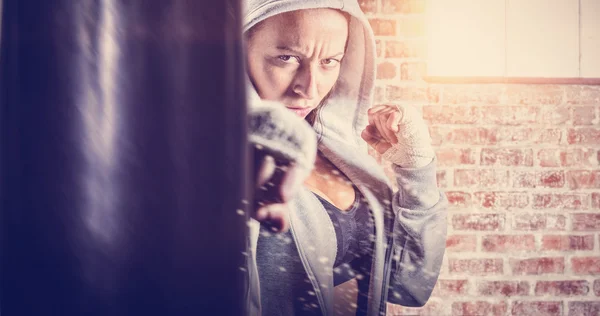 Female fighter in hood with fight