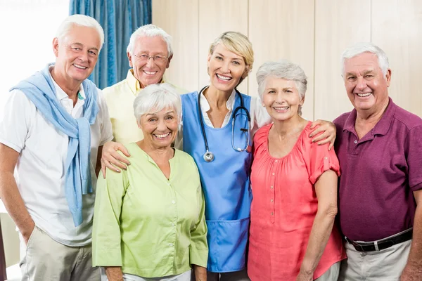 Seniors and nurse standing in a row