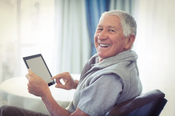 Senior man using digital tablet