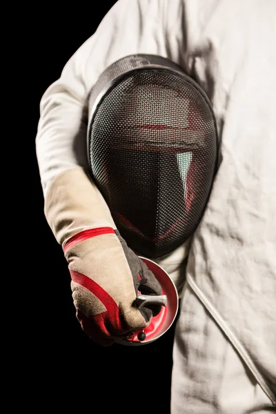 Mid-section of man standing with fencing mask