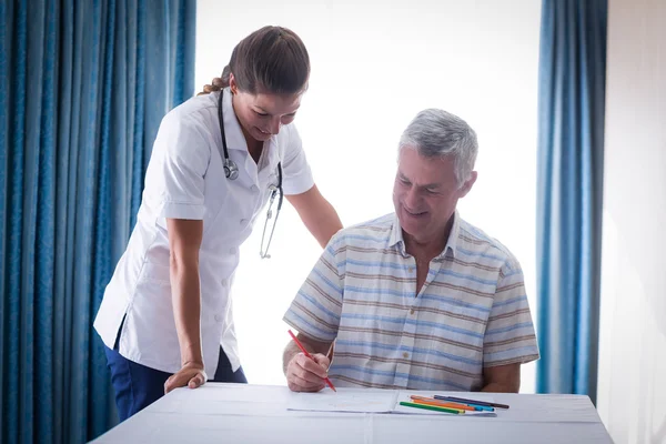 Doctor assisting a senior man