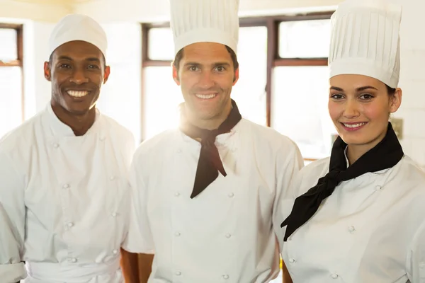Three chefs in commercial kitchen