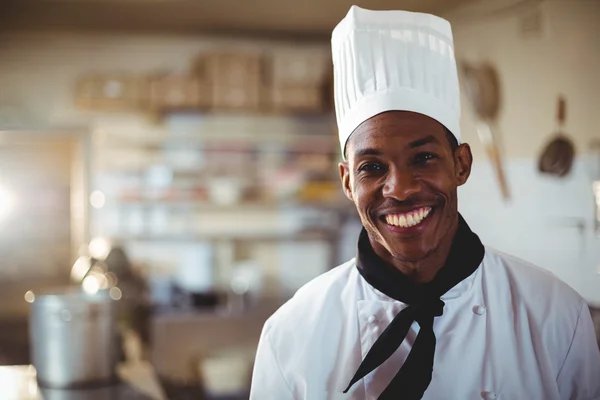 Smiling chef in commercial kitchen