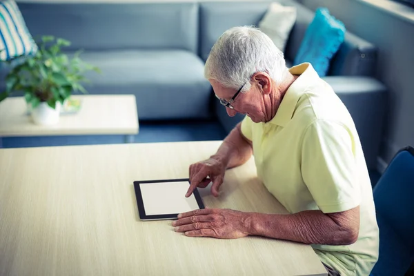 Senior man using digital tablet