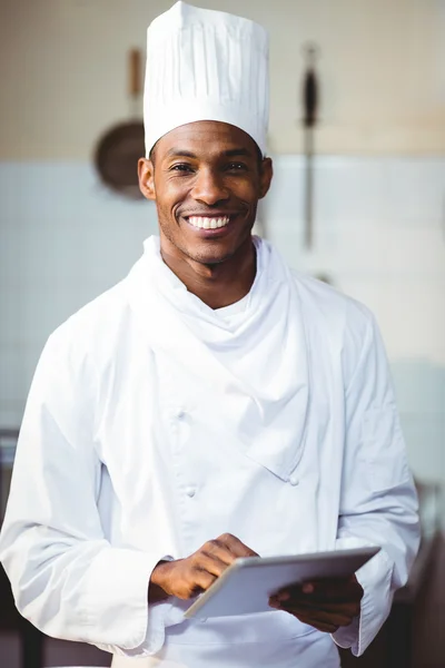 Smiling chef using tablet