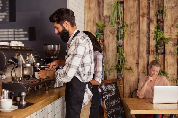 Waiters using coffee machine